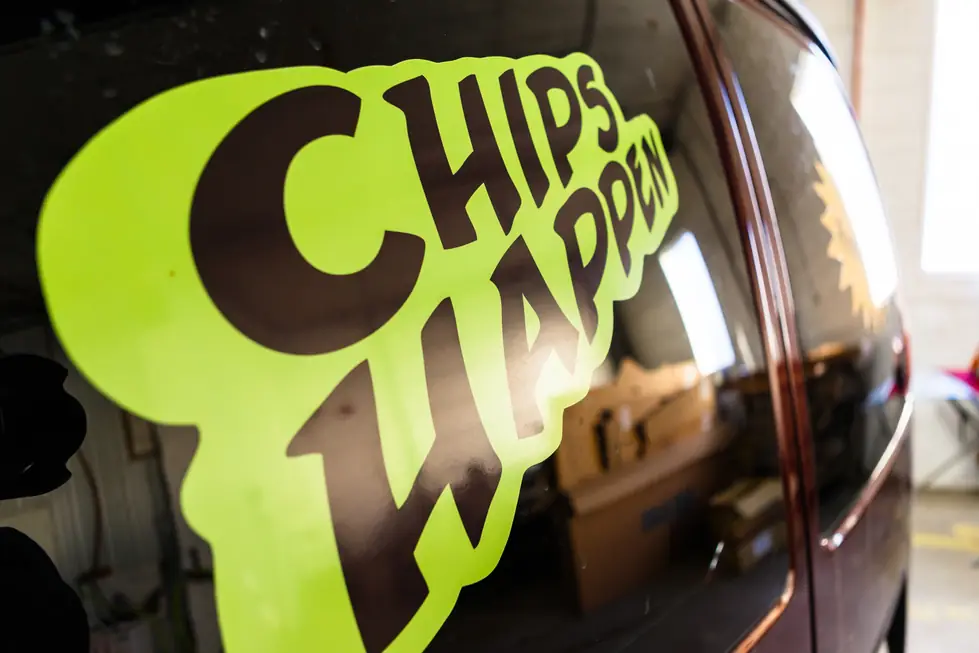 Close-up of the lime green 'Chips Happen' decal on a Fas-Break mobile repair van